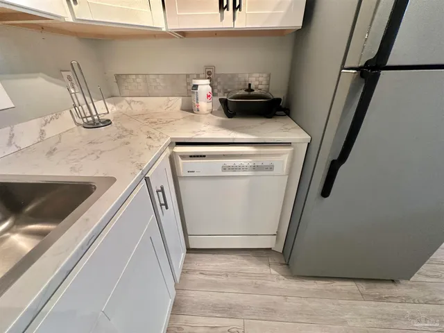 a utility room with sink dryer and washer