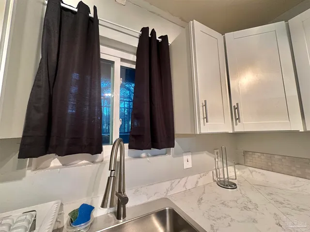 a kitchen with a sink and a refrigerator