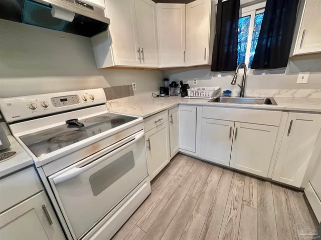 a kitchen with cabinets and appliances