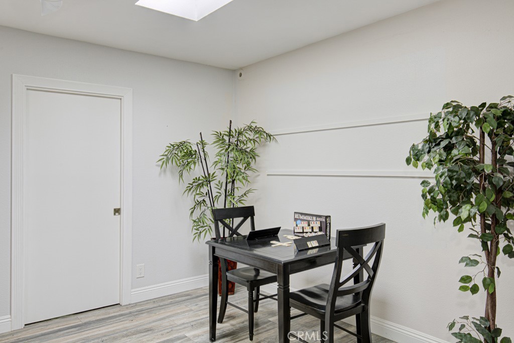 245 Calle Aragon, Unit C Laguna Woods, CA 92637 - Photo 11 of 32 a view of a dining room with furniture and wooden floor