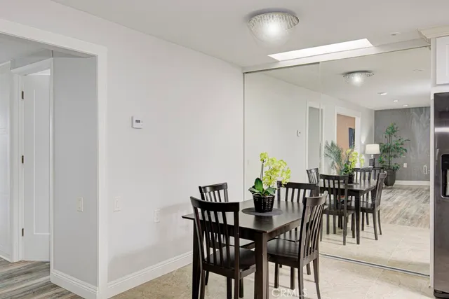 a view of a dining room with furniture and a potted plant