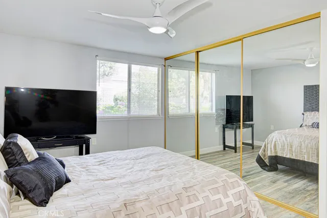 a bedroom with a bed and a flat screen tv