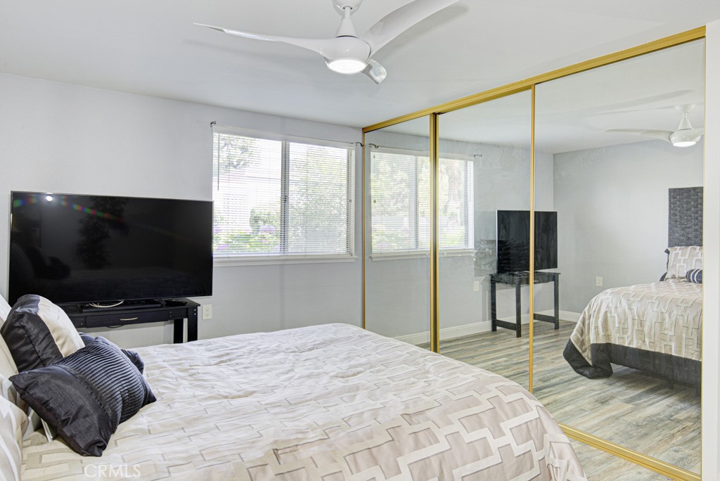 245 Calle Aragon, Unit C Laguna Woods, CA 92637 - Photo 18 of 32 a bedroom with a bed and a flat screen tv