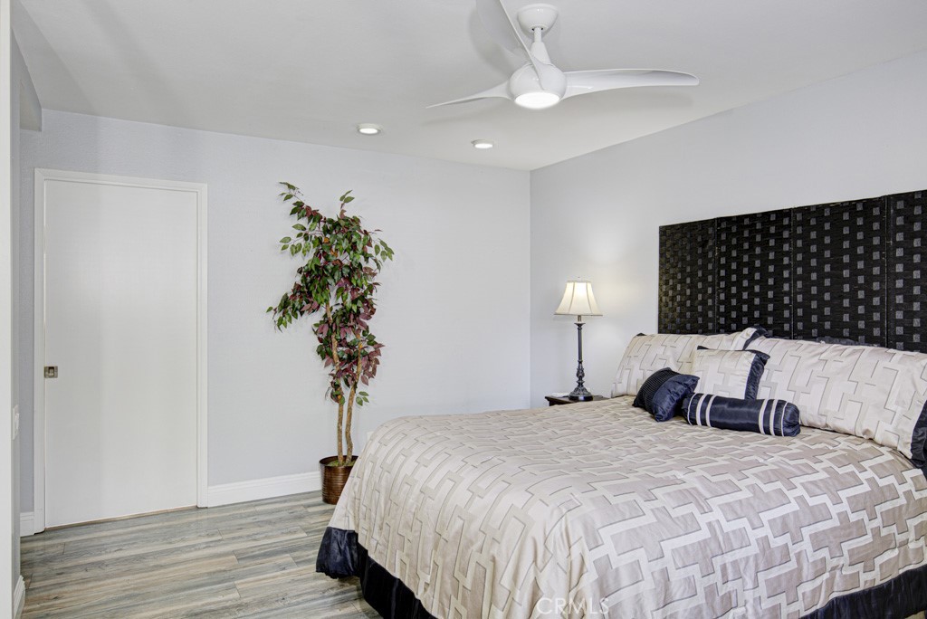 245 Calle Aragon, Unit C Laguna Woods, CA 92637 - Photo 19 of 32 a bedroom with a bed and a potted plant