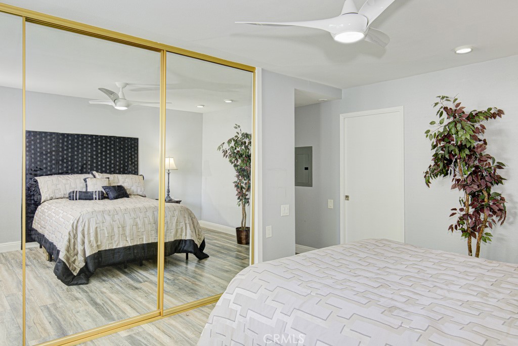 245 Calle Aragon, Unit C Laguna Woods, CA 92637 - Photo 20 of 32 a bedroom with a bed and a potted plant