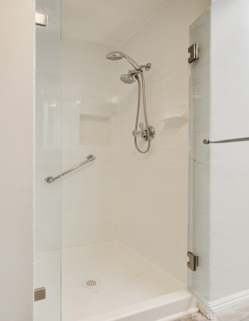 245 Calle Aragon, Unit C Laguna Woods, CA 92637 - Photo 23 of 32 a bathroom with a shower