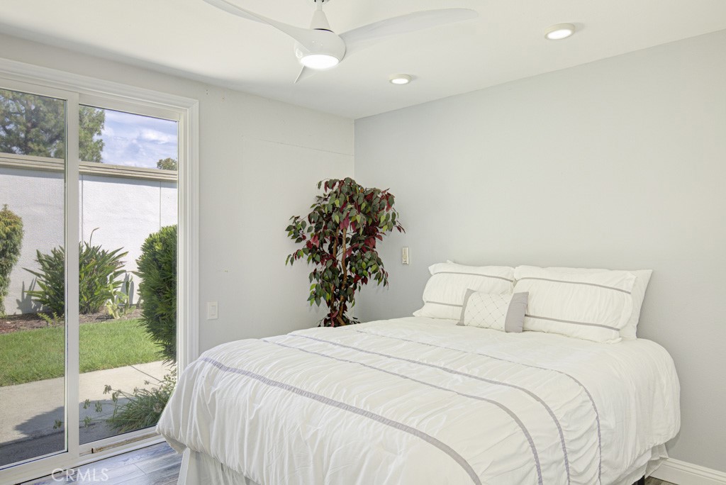 245 Calle Aragon, Unit C Laguna Woods, CA 92637 - Photo 24 of 32 a bedroom with a bed and a potted plant
