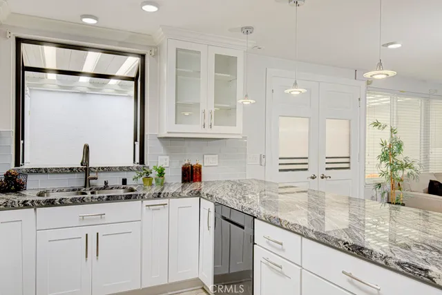 a kitchen with stainless steel appliances granite countertop a sink and cabinets