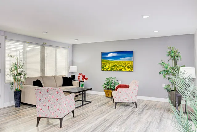 a living room with furniture and a potted plant