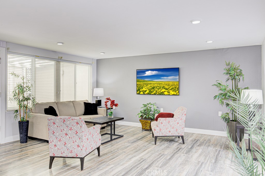 245 Calle Aragon, Unit C Laguna Woods, CA 92637 - Photo 6 of 32 a living room with furniture and a potted plant