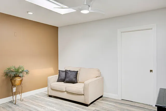 a living room with a couch and a potted plant