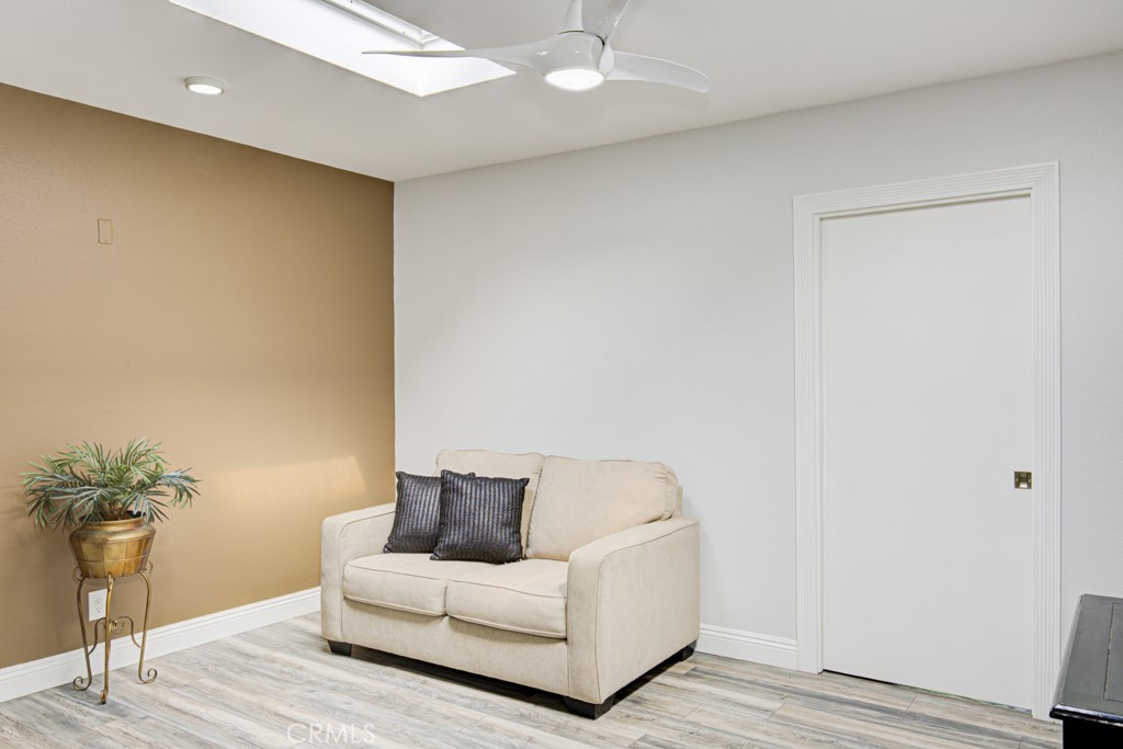 245 Calle Aragon, Unit C Laguna Woods, CA 92637 - Photo 10 of 32 a living room with a couch and a potted plant