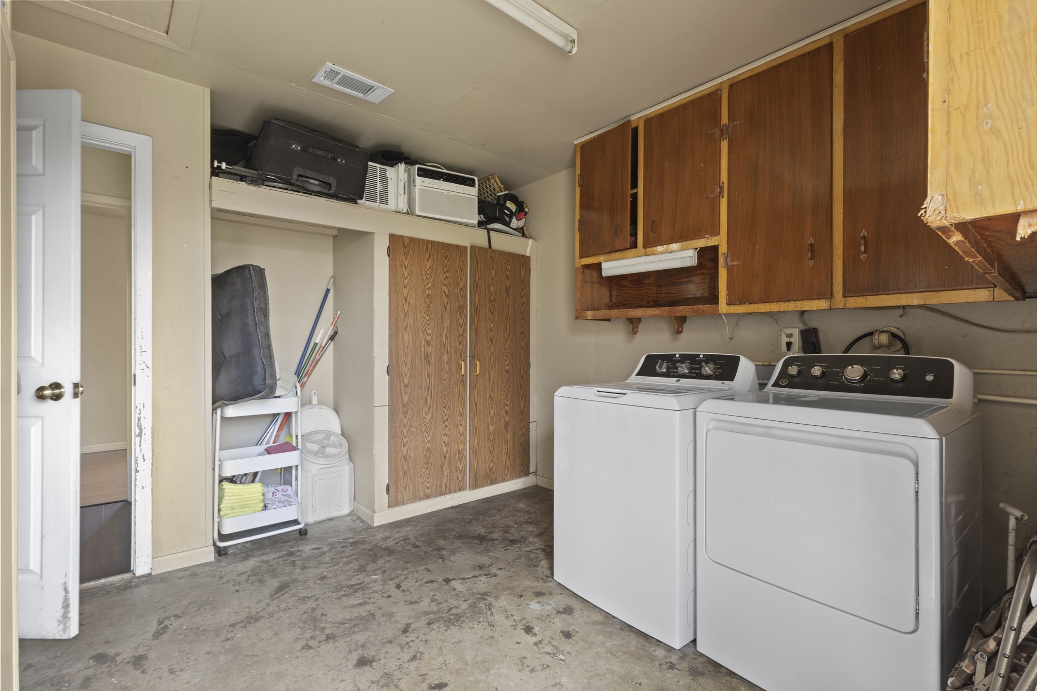 19961 Englin Road Winnie, TX 77665 - Photo 26 of 26 a kitchen with refrigerator and cabinets