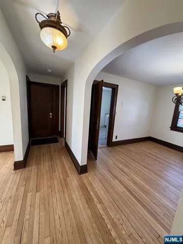 a view of a room with wooden floor and window