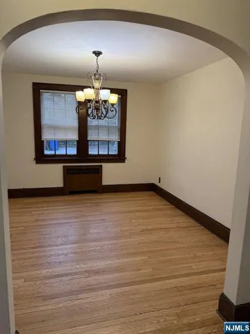 a room with wooden floor and window