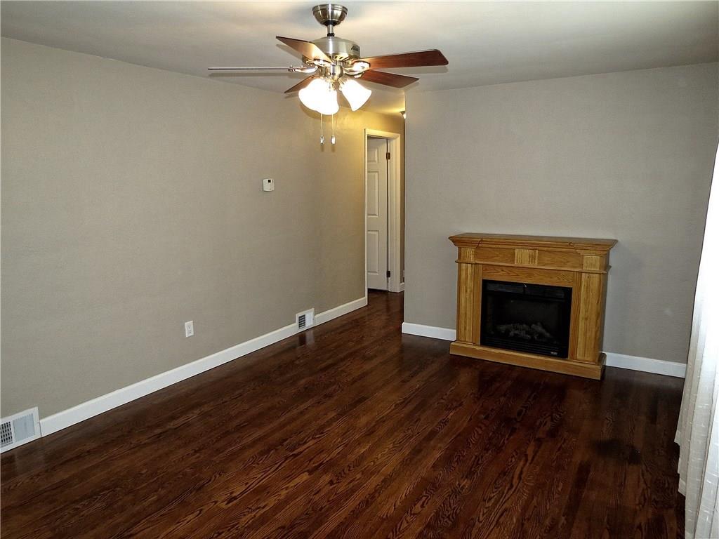 The 16 X 11.5 living room is warmed by beautiful walnut stained hardwood floors.
