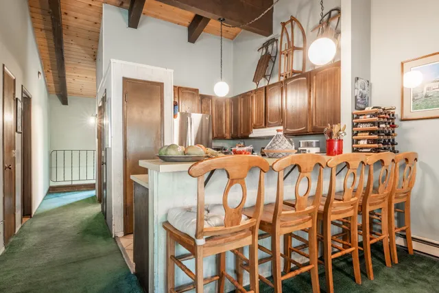 a kitchen with stainless steel appliances kitchen island granite countertop a refrigerator and cabinets