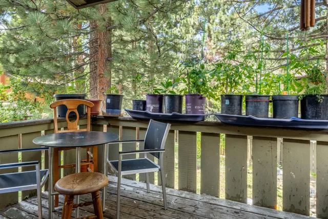 a backyard of a house with table and chairs