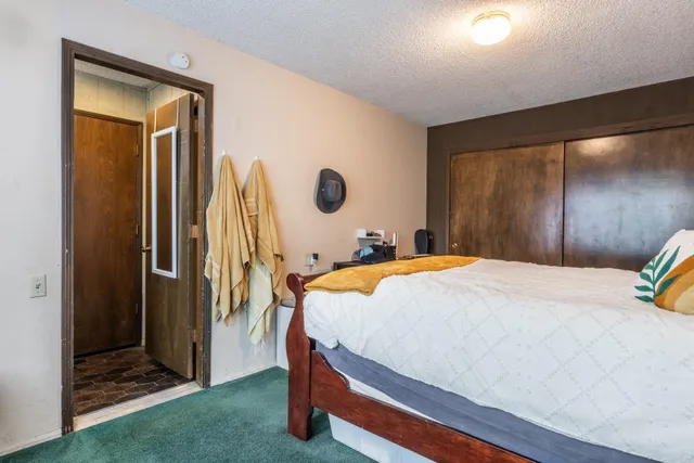 a bedroom with a bed and a mirror