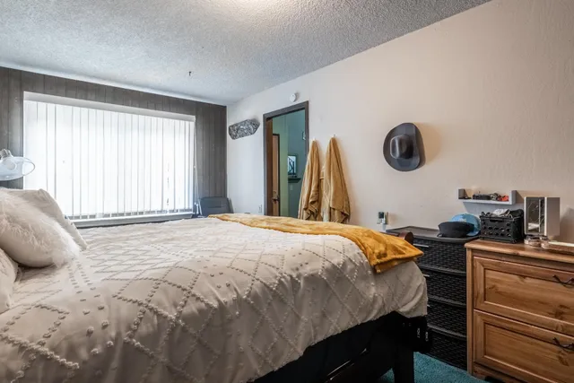 a bedroom with a bed and a chandelier