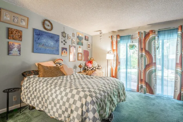 a bedroom with a large bed and a chandelier