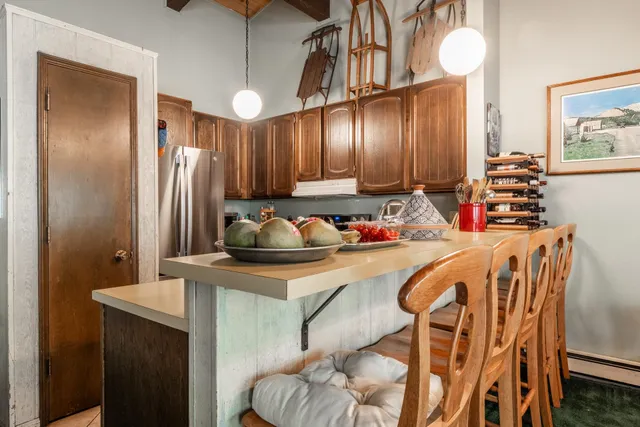 a kitchen with stainless steel appliances granite countertop a sink refrigerator and cabinets
