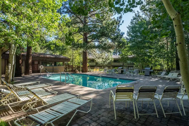 a view of a backyard with sitting area