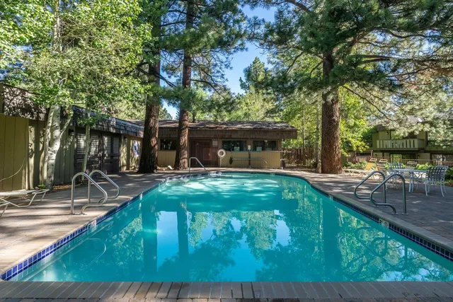 a view of house with backyard and outdoor seating