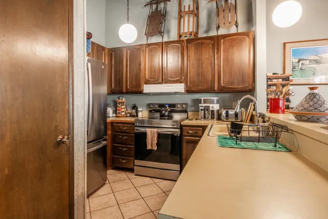 a kitchen with cabinets a sink and appliances