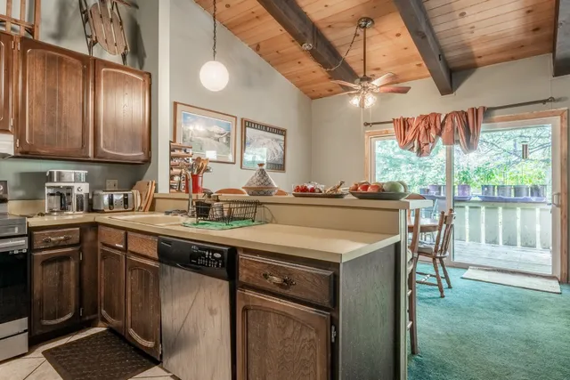 a kitchen with stainless steel appliances granite countertop a sink a stove and a refrigerator