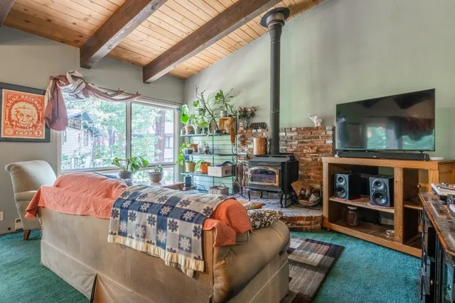 a living room with fireplace furniture and a flat screen tv