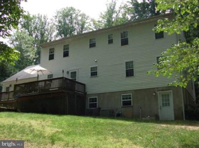 8258 Sycamore Road Lusby, MD 20657 - Photo 22 of 24 a view of a house with a yard