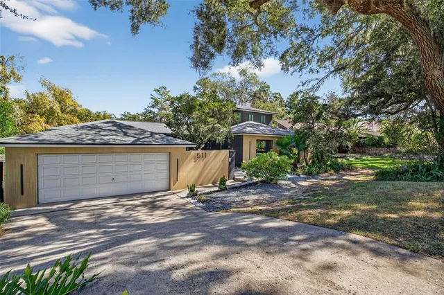 a view of a house with yard and a tree