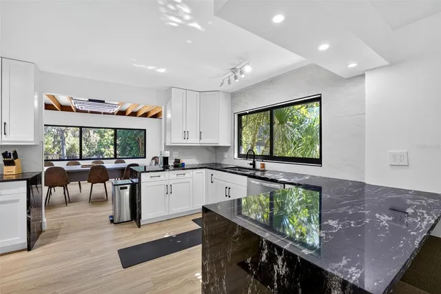 a kitchen with lots of counter top space and wooden floor