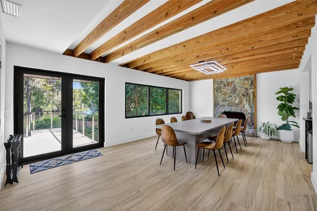 a dining room with furniture window and wooden floor