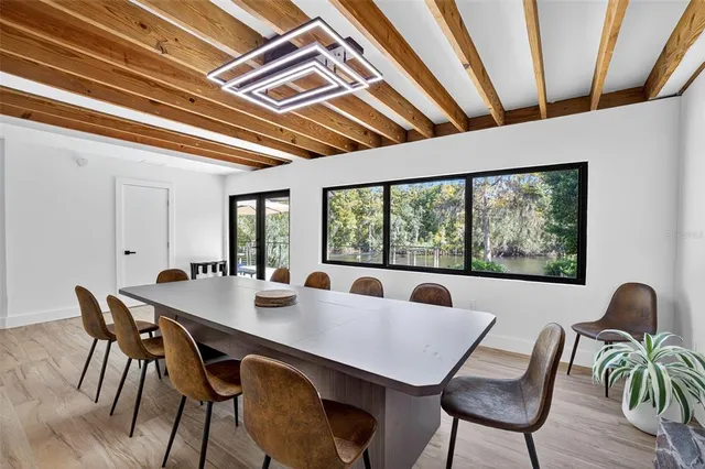 a view of a dining room with furniture window and wooden floor
