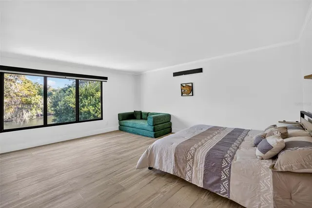 a bed sitting in a bedroom next to a window