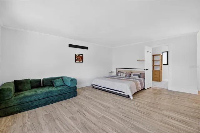 a living room with a couch and a wooden floor