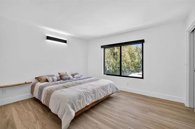 a bedroom with two beds and a window