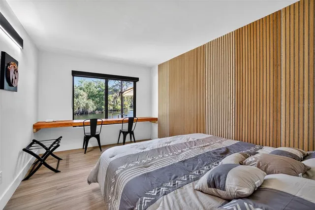 a bed room with a bed and a chair