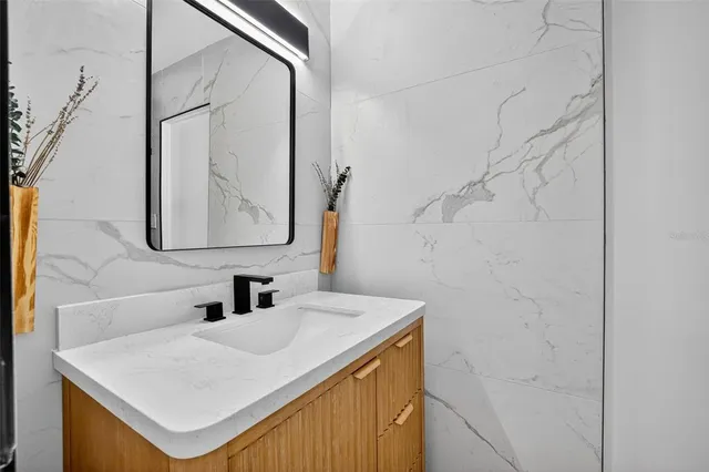 a bathroom with a sink vanity and a mirror