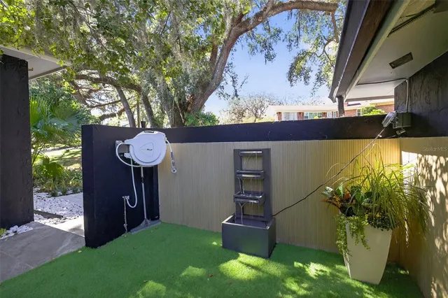 a view of a backyard with wooden fence