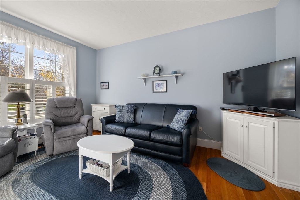 96 Walden Way, Unit 52 Milford, MA 01757 - Photo 13 of 23 a living room with furniture and a flat screen tv