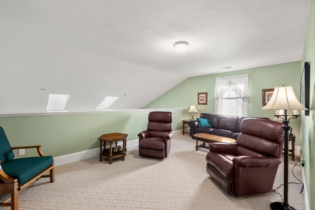 96 Walden Way, Unit 52 Milford, MA 01757 - Photo 16 of 23 a living room with furniture and a mirror