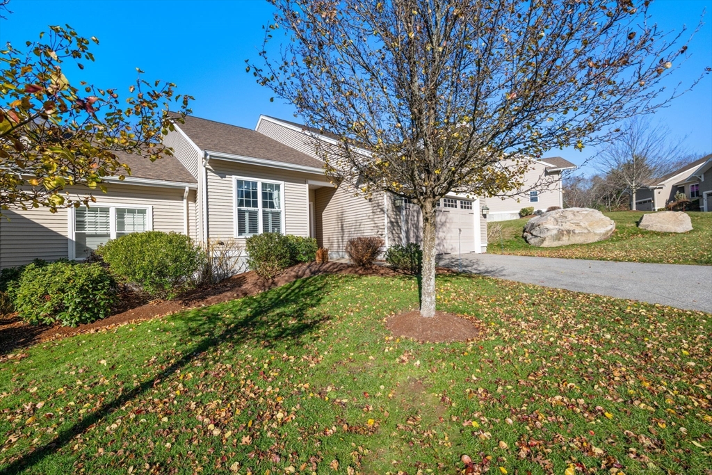 96 Walden Way, Unit 52 Milford, MA 01757 - Photo 20 of 23 a house with green field in front of it