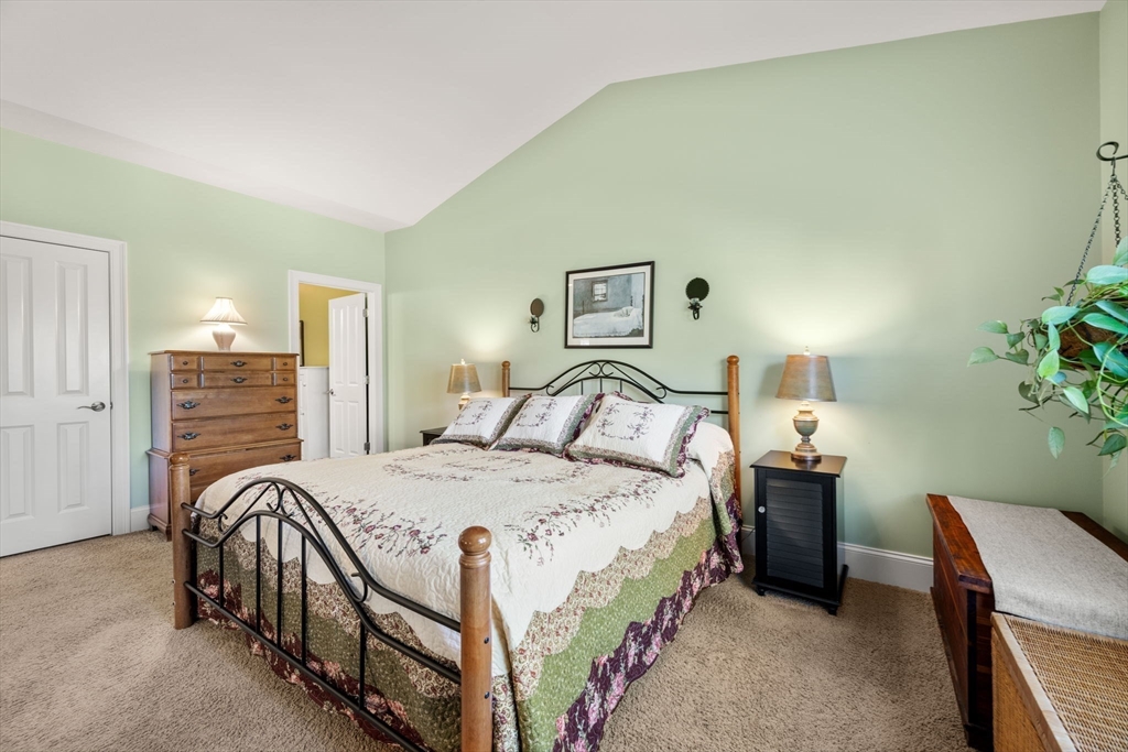 96 Walden Way, Unit 52 Milford, MA 01757 - Photo 10 of 23 a bedroom with a bed and a table
