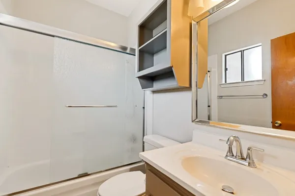 a bathroom with a sink toilet and shower