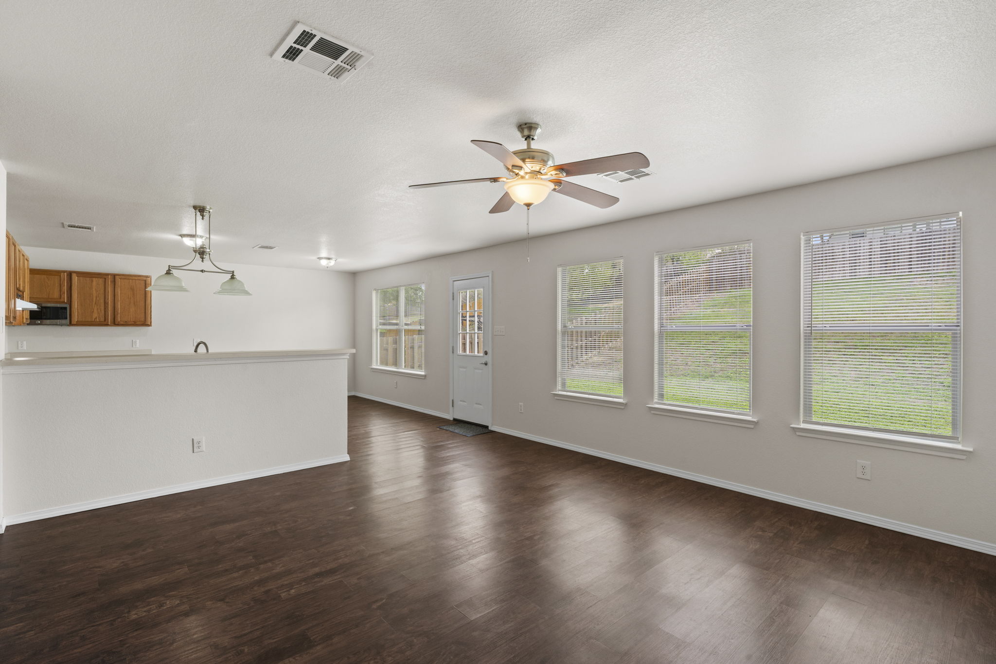 208 Dandelion Loop Kyle, TX 78640 - Photo 15 of 39 The property features flooring and light-colored walls, creating a bright and open atmosphere