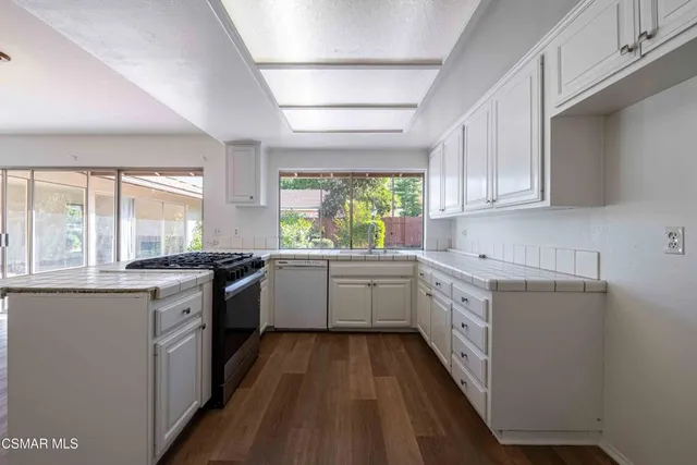 a kitchen with a sink stove and refrigerator