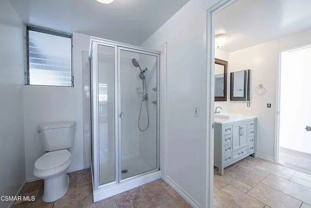 a bathroom with a toilet a sink and shower
